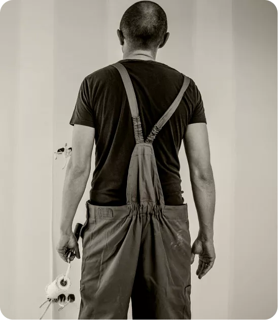 Professional painter applying a fresh coat to an interior wall with a roller